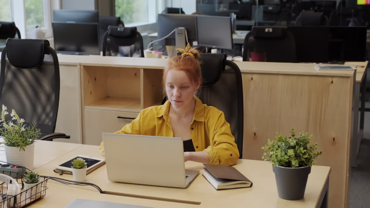 Red-Haired Woman Working In Office