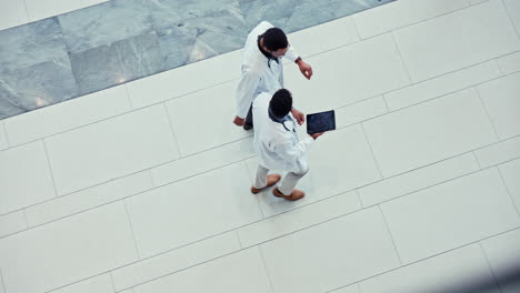 Doctors,-tablet-and-walking-in-a-hospital