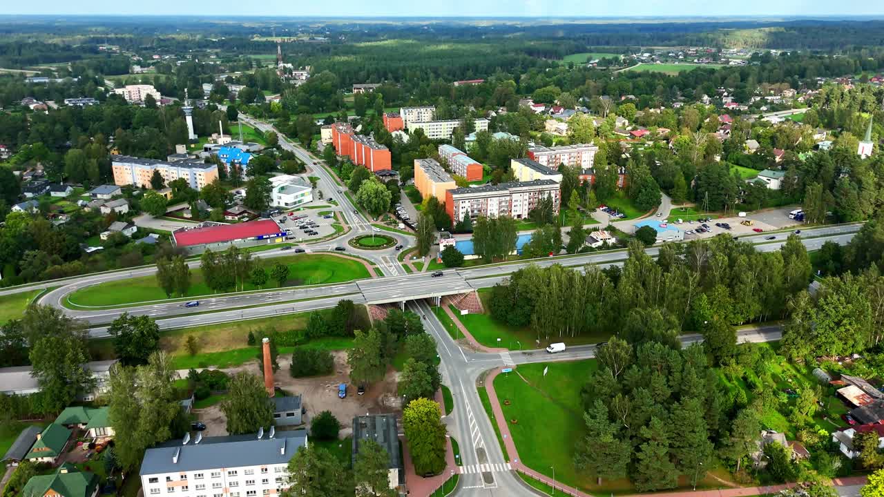 Drone flyover revealing Ikskile’s urban planning, roads, and neatly aligned buildings, tilt up