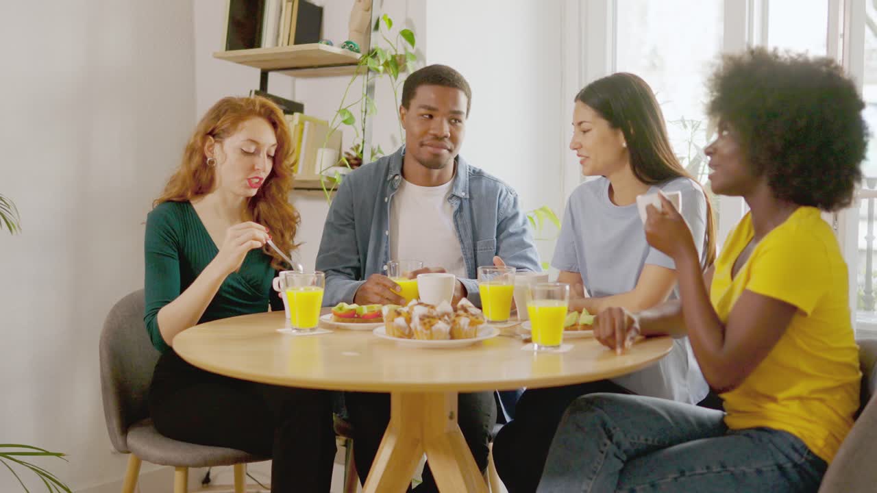 Diverse group of friends enjoying breakfast and conversation