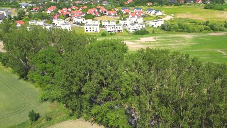 Aerial-view-of-residential-houses-neighborhood-and-apartment-building-complex-at-sunset