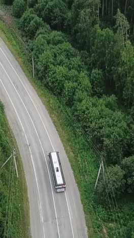 bus on a road through a forest
