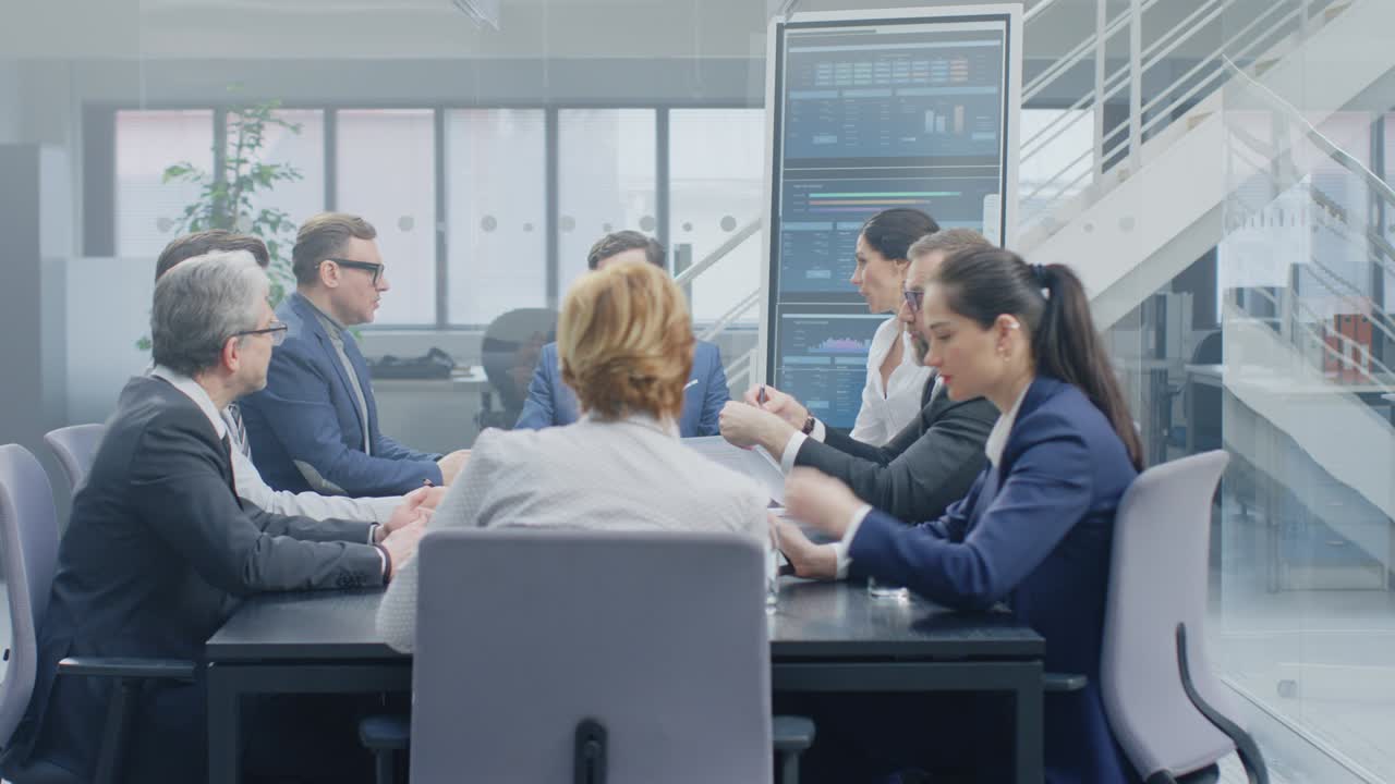 In the Modern Corporate Office Meeting Room: Diverse Group of Businesspeople, Lawyers, Executives and Members of the Board of Directors Talking, Negotiating and Working on a Winning Strategy.