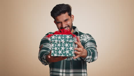 indian man presenting birthday gift box offer wrapped present career bonus celebrating party sale