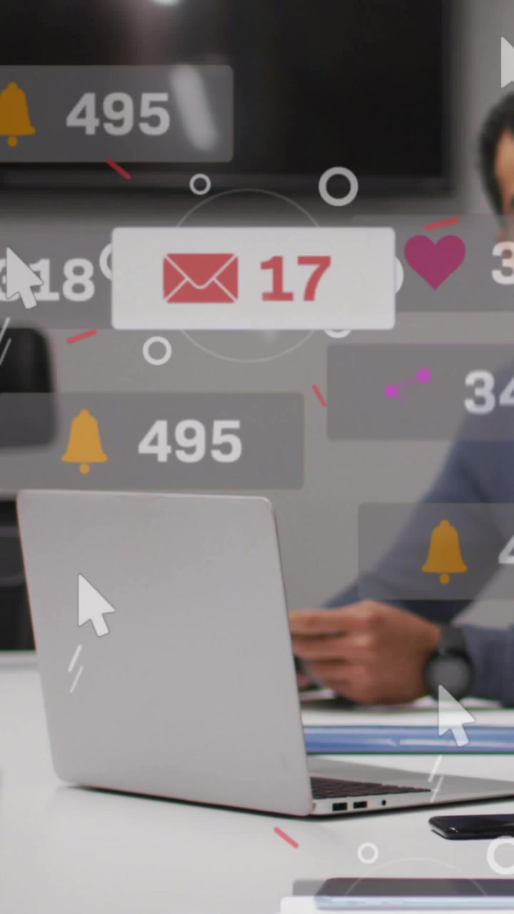 Vertical video: Man tapping phone at table, social media alerts floating across laptop tracking ROI