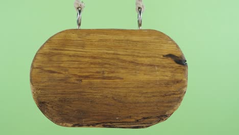 panorama, of a hanging wooden sign. isolated on green screen.