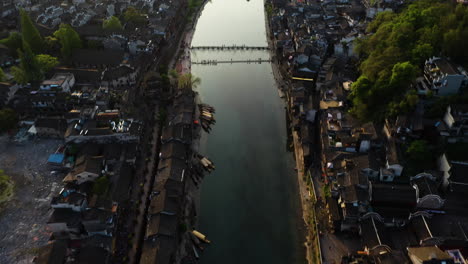 aerial tilt reveal over the tuo jiang river and the fenghuang county, sunrise in china