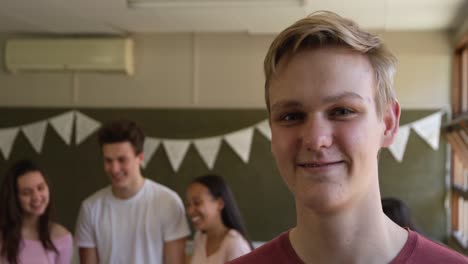 Portrait-of-teenage-boy-in-school-classroom