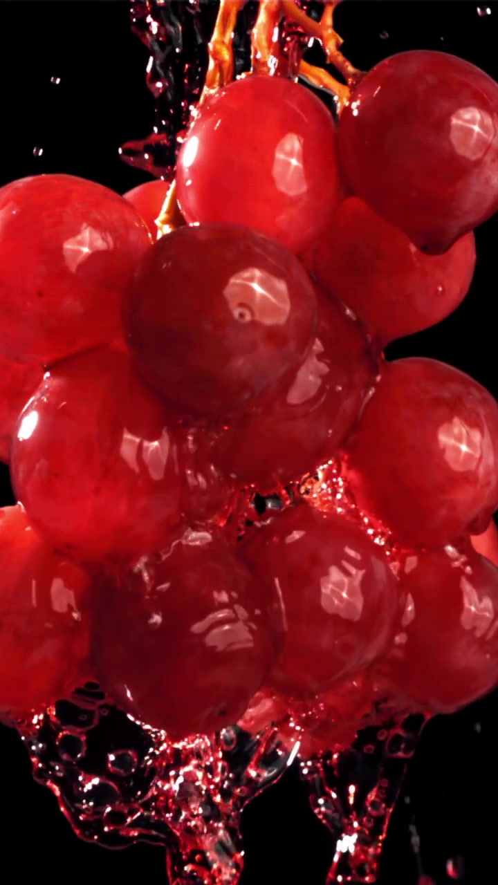 Fresh Red Grapes with Water Splashing on Black Background