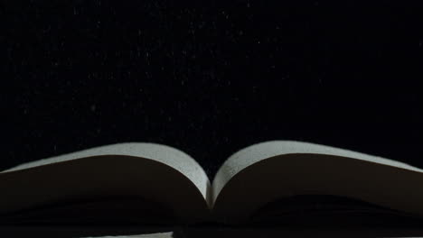 open book with flying dust