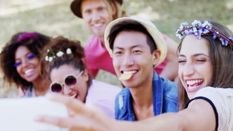 friends taking selfie with mobile phone in park 4k