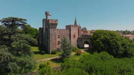 medieval château de pouzilhac against verdant backdrop - aerial