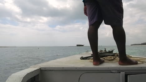 a boat sails the indian ocean in watamu, kenya.