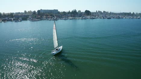 a nice pass and pan down over the sailboat in the marina on a sunny day