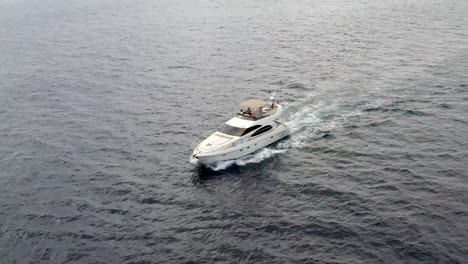 Luxury-boat-yacht-traveling-through-ocean,-aerial-drone-tracking