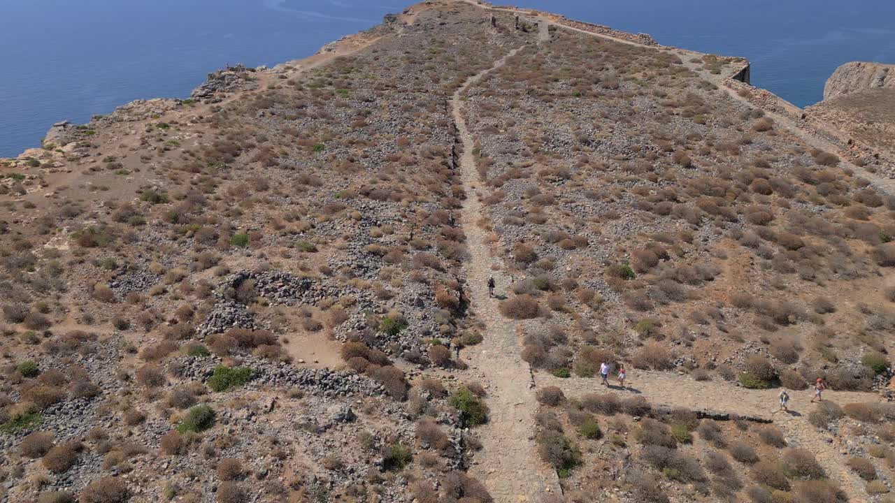 Revealing the landscape of Gramvousa Fortress in Crete, following the path that leads to its historic ruins above the sea