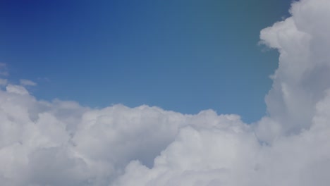 view of large clouds outside of chromatic airplane window, santorini, greece, europe