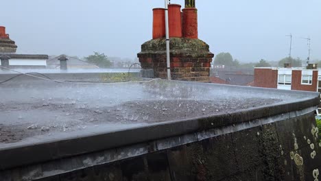 heavy rain downpour on a flat residential roof