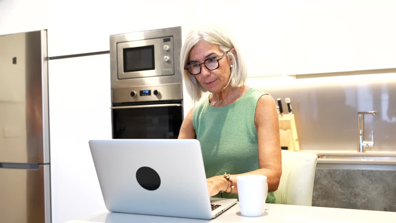 Women in the kitchen using a laptop