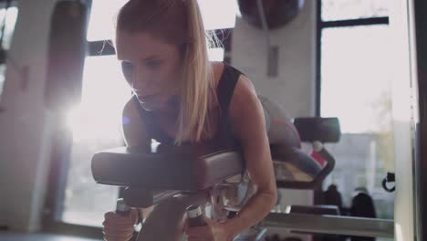 handheld view of woman during hard workout in the gym