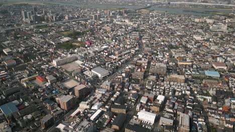 aerial scenic urban drone footage of a neighborhood, streets and buildings in the capital city of tokyo, japan during sunset