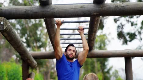 fit man climbing monkey bars 4k