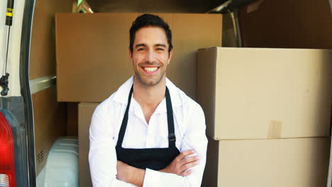 smiling delivery man sitting in his van