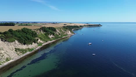 ven island, sweden: drone zooming in over the rugged coastline of ven island in summer