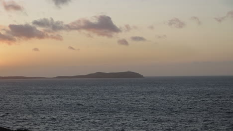 view from a tropical beach to the sea at sunset