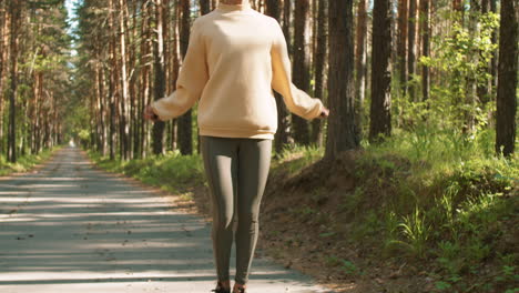 woman jumping rope in a forest path