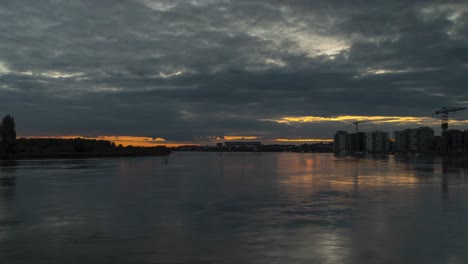 Beautiful-river-motion-with-view-of-Antwerp-city-buildings,-time-lapse-shot