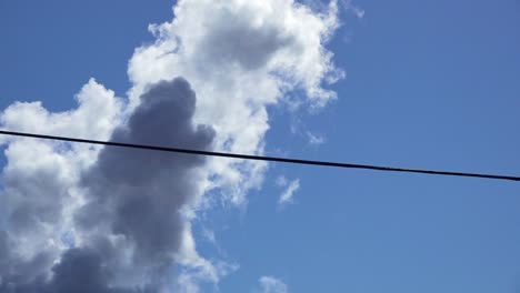 Steam-venting-into-sky-from-factory-camera-closeup-and-tilt