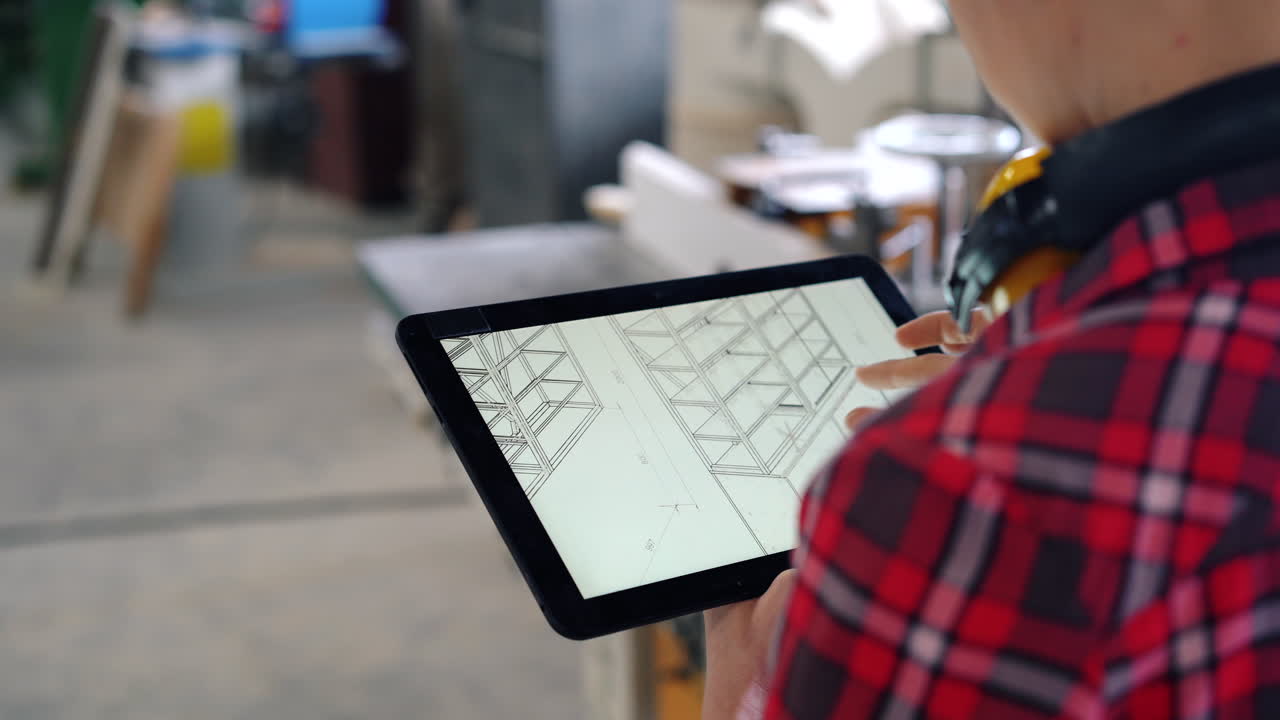 Woodworker reviewing design plans on tablet