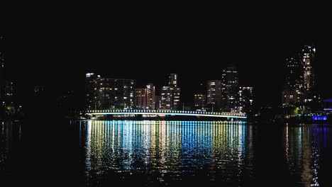 timelapse of nighttime cityscape across water