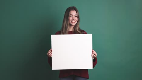 woman holding a blank panel while smiling at the camera