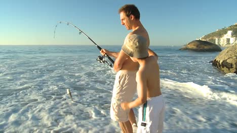 attractive man fishing with his son