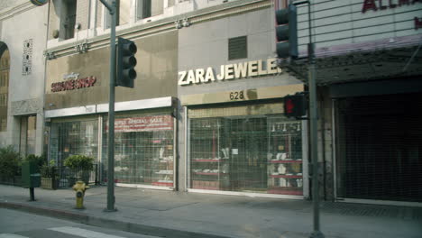 street view of closed shops with security gates