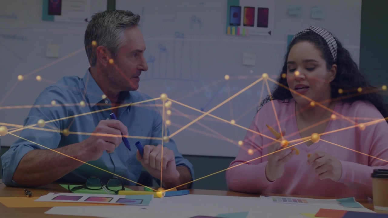 Man placing blue marker, sliding layout to woman, both annotating business design, refining mockup