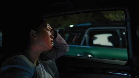 business chinese woman driving in a taxi at night