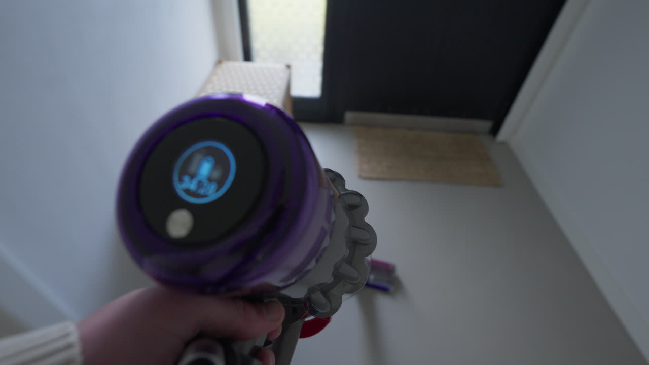 Handheld vacuum cleaner in action in a modern home setting
