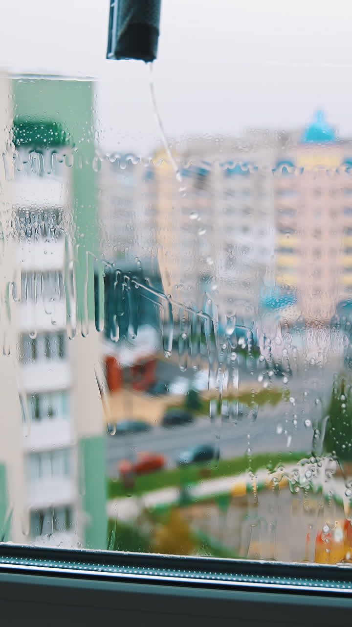 Water cleaner with wet glass. Close up view of cleaning wet window. Vertical video