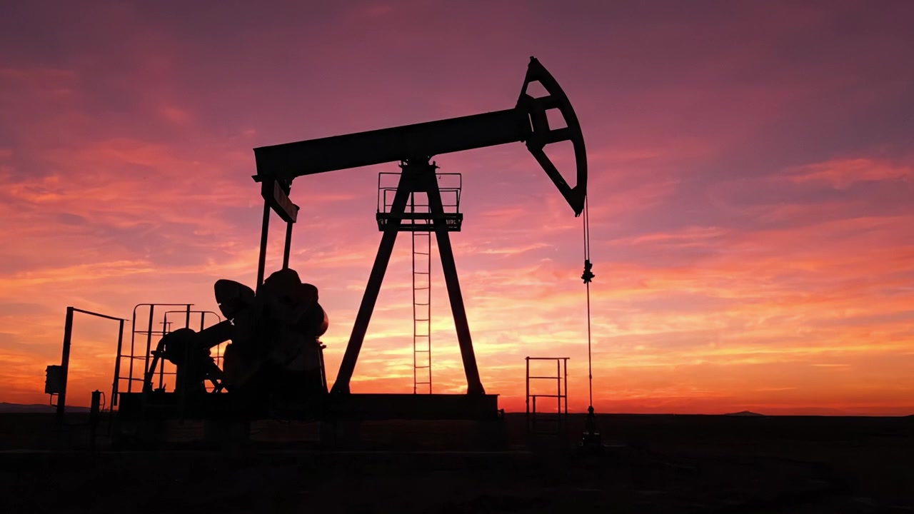 A Stunning Sunset Silhouette of an Oil Pump Jack Against a Vibrant Skyline, Capturing the Beauty of Nature and Industrial Machinery in Harmony