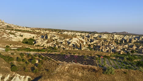 göreme turkey aerial v68 panoramic sunrise landscape view, drone fly around plateau field capturing spectacular rock formations and hot air balloons in the sky - shot with mavic 3 cine - july 2022