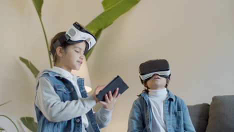 two kids having fun playing with virtual reality glasses