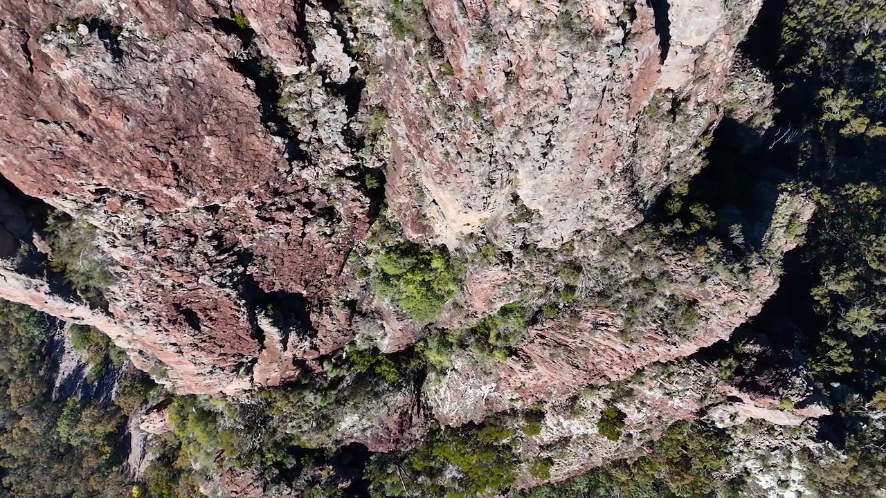 Top down aerial view of ancient volcanic rock formations in Warrumbungle National Park, Australia.