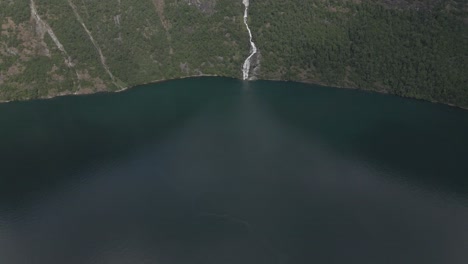 Aerial-tilt-up-view-of-Bringefossen-with-green-mountain-in-Geiranger-fjord,-Norway