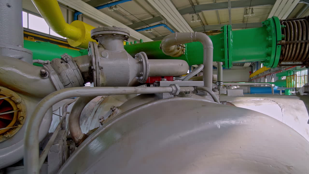 A close-up of the turbocharger of a large industrial gas compressor engine inside a pumping station facility used for transporting natural gas through a pipeline in Latvia