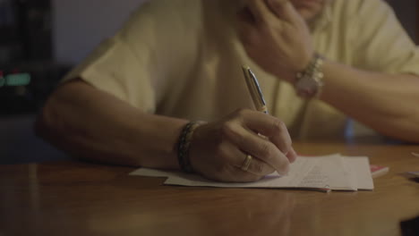 person writing at a desk