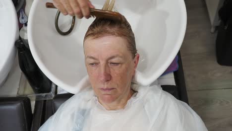 woman getting her hair washed at a hair salon