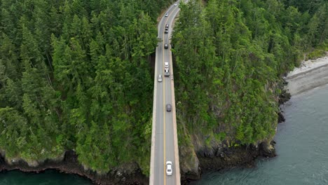 Top-down-aerial-shot-of-cars-commuting-across-a-bridge-in-the-Pacific-North-West